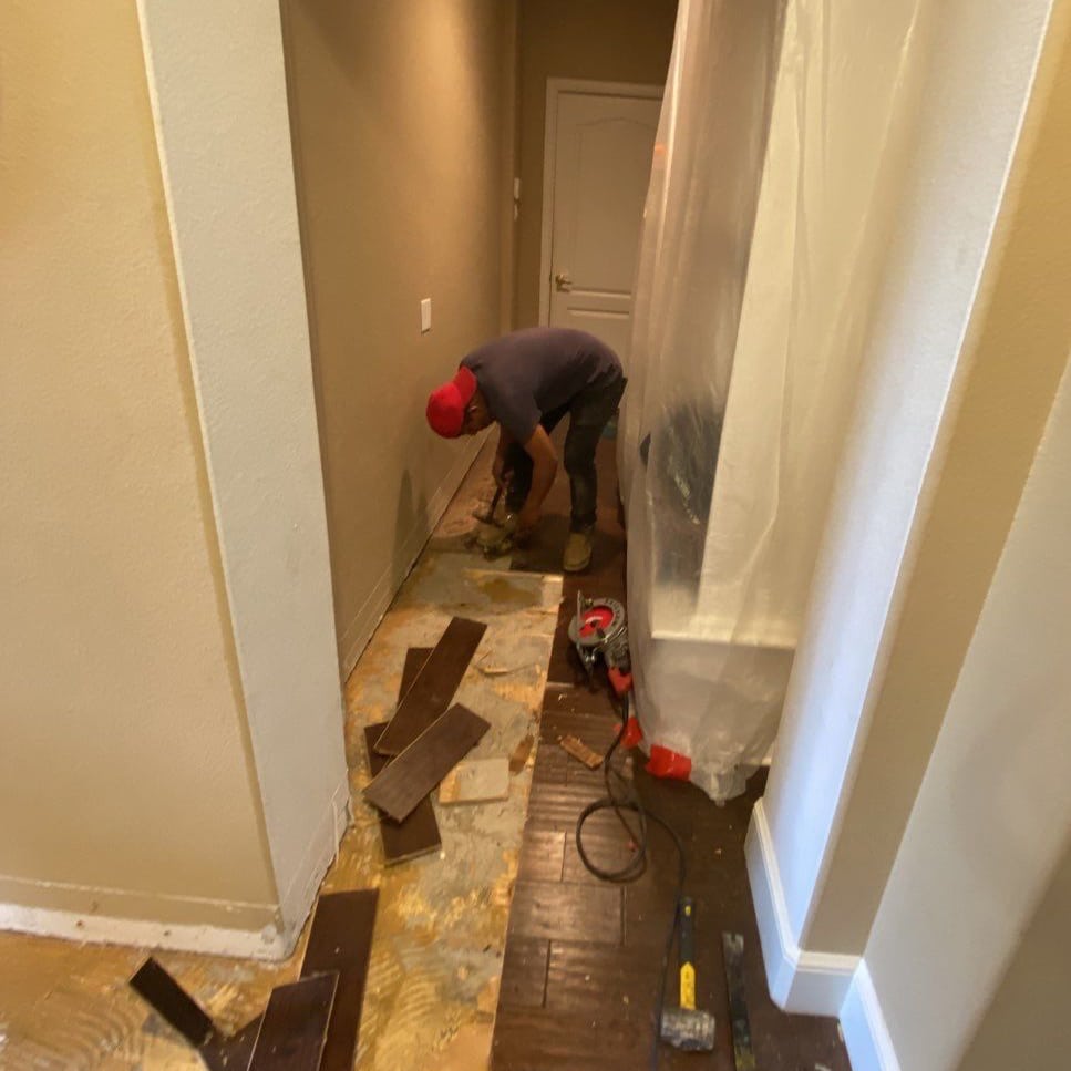 Zeus employee restoring a damaged hallway